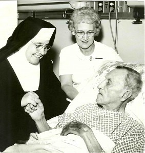 Mother Margarita bedside to a patient in 1966