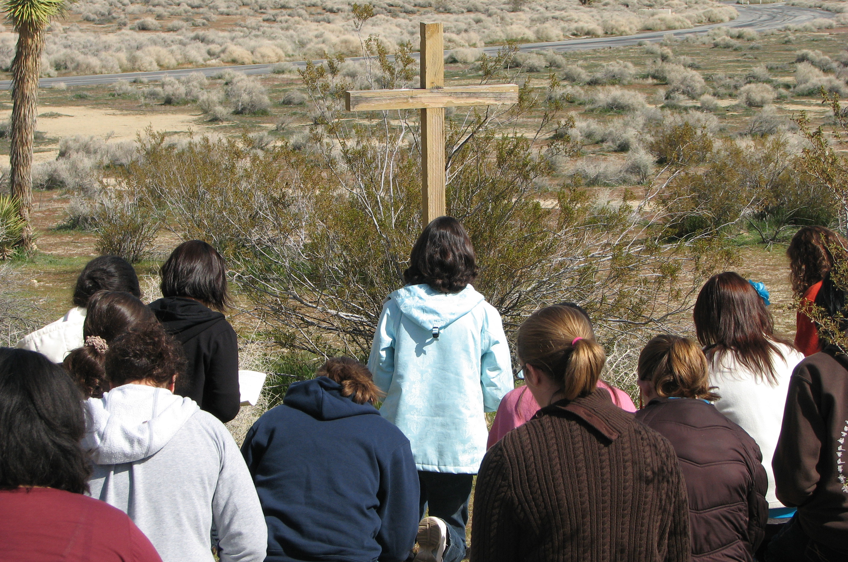 Mother Luisita Pilgrimage, women praying before a cross