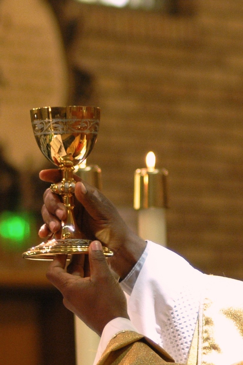 Priest holding Chalice up during Consecration