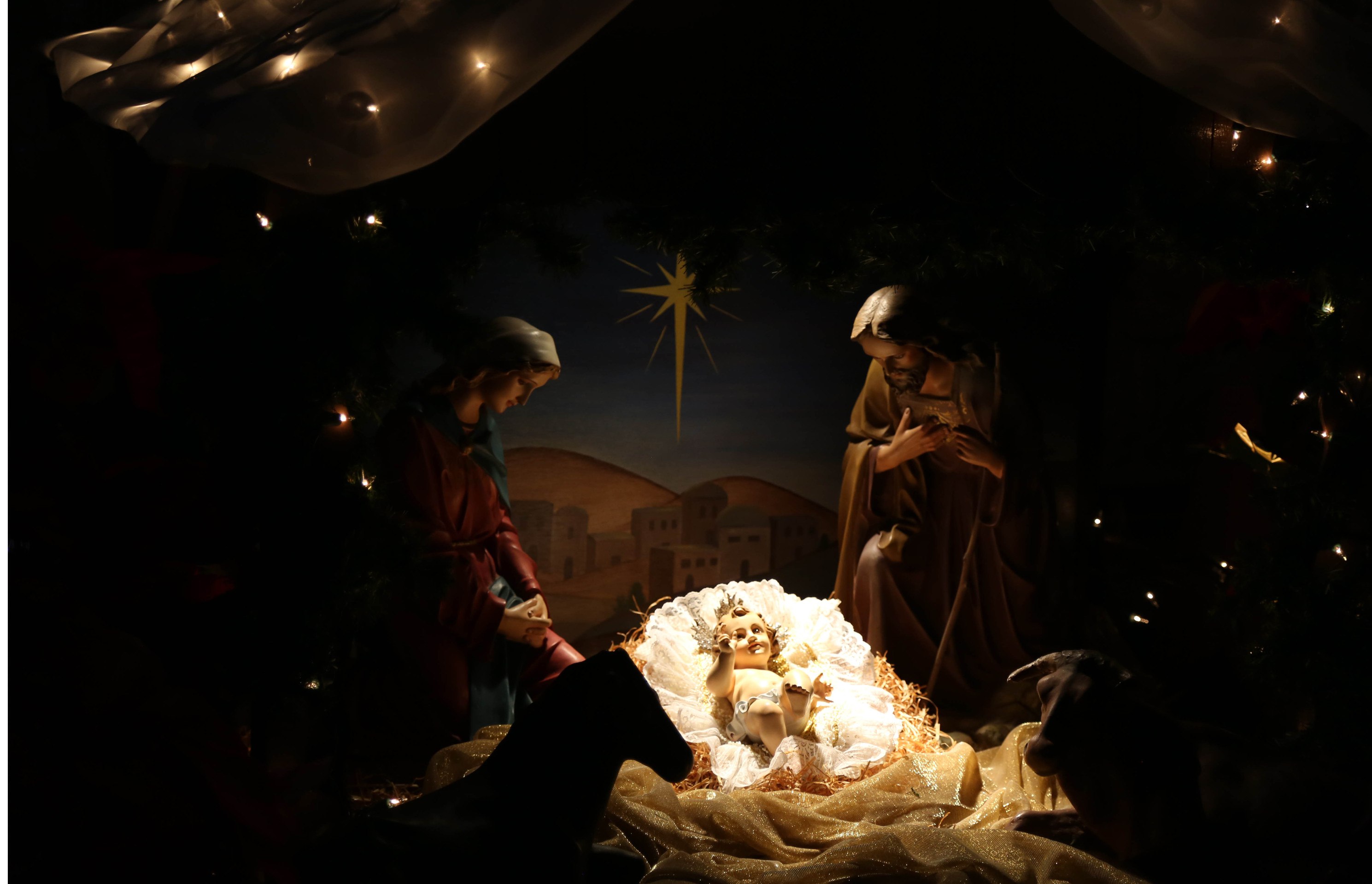 Statues of baby Jesus in manger with Mary and Joseph next to him