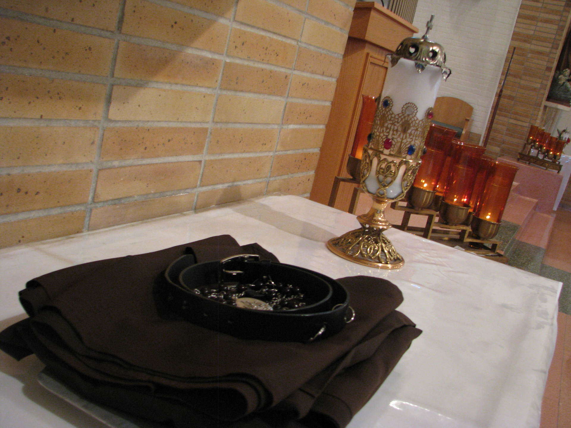 Habit, belt and rosary resting on altar