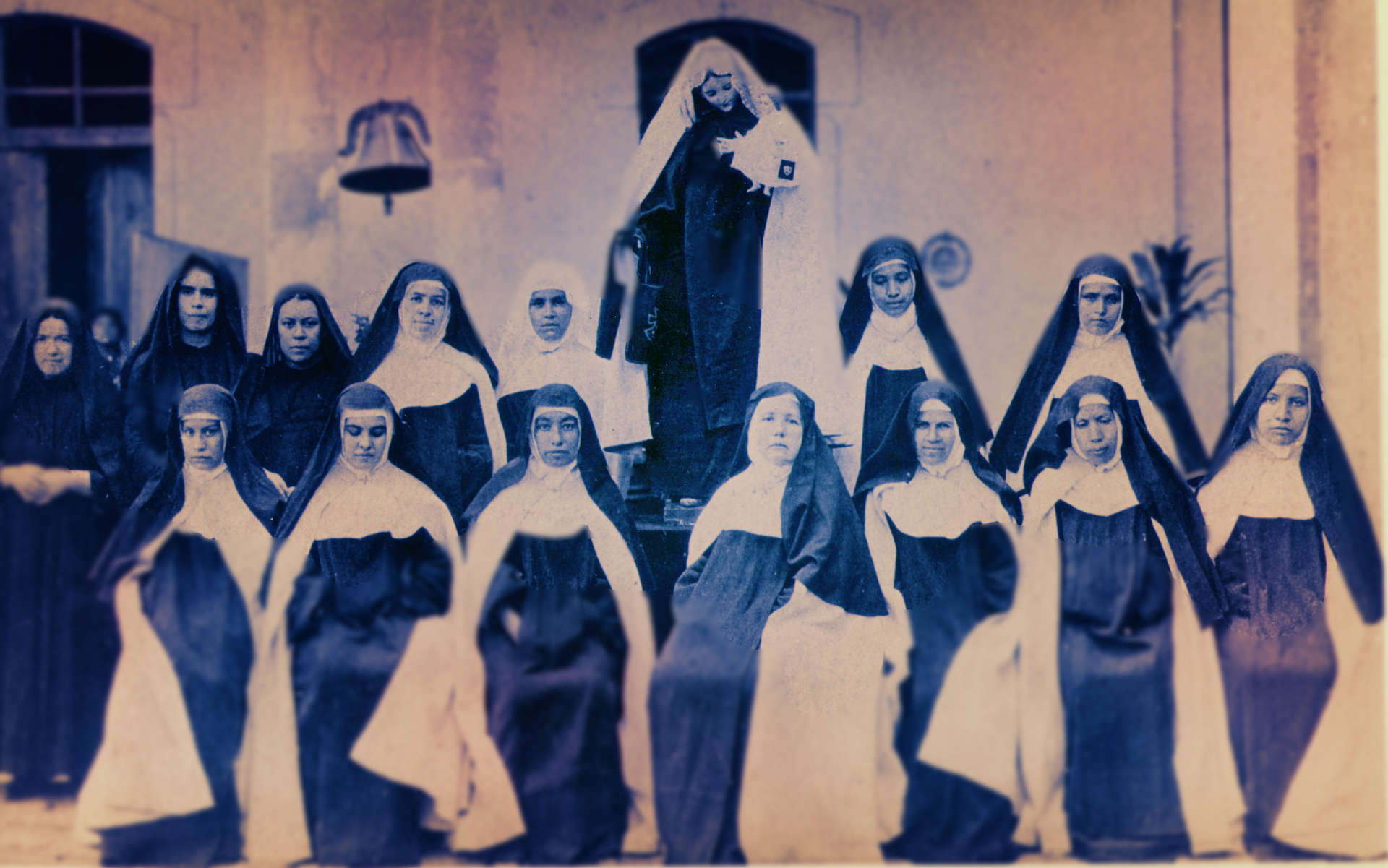 Historical photo of the Carmelite Sisters in front of Mary Statue