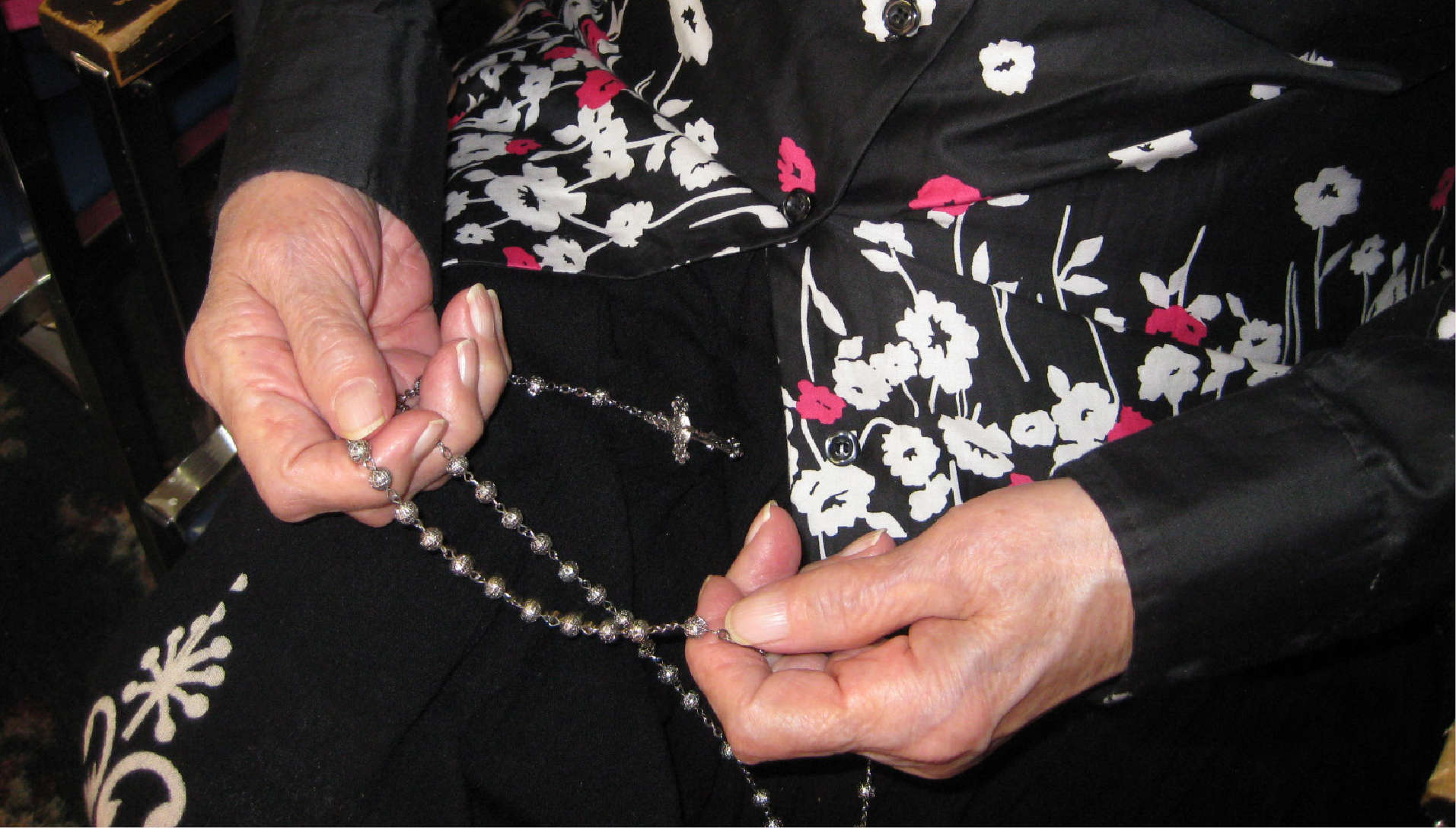 woman holding rosary in hands