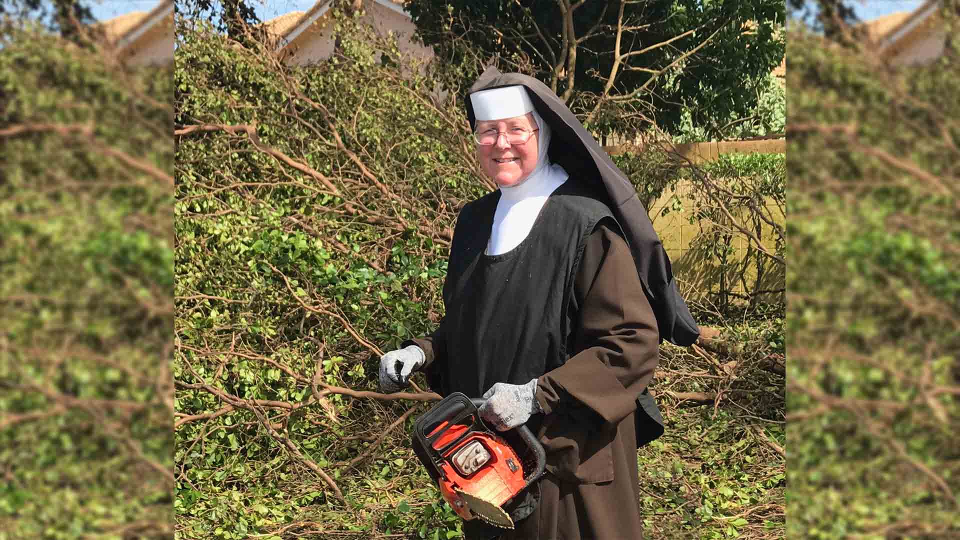 photo of a Sister with chainsaw outside