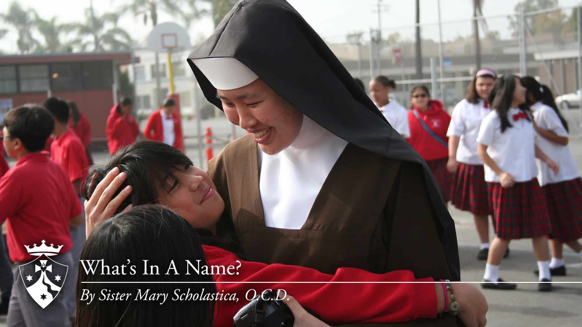 Sister hugging student with school kids outside, 'What's in A Name? By Sister Mary Scholastica, O.C.D.'