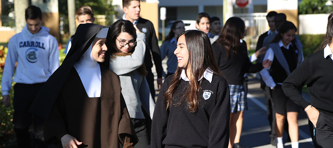 Sister walking with students outside