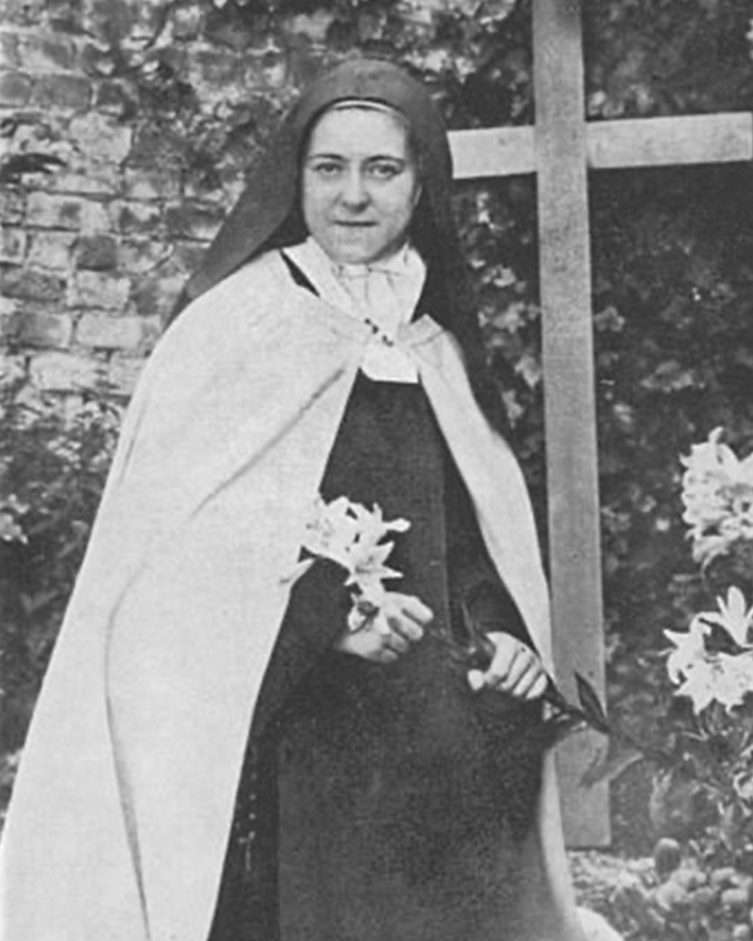 St. Therese posing by a cross for her Jubilee picture.